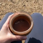 Healthy, vegan hot chocolate in a travel cup being enjoyed on a walk